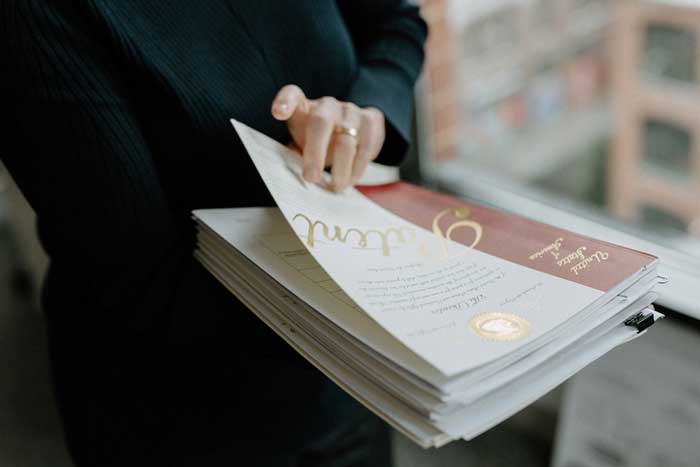 A person holds a sheets of paper of patents